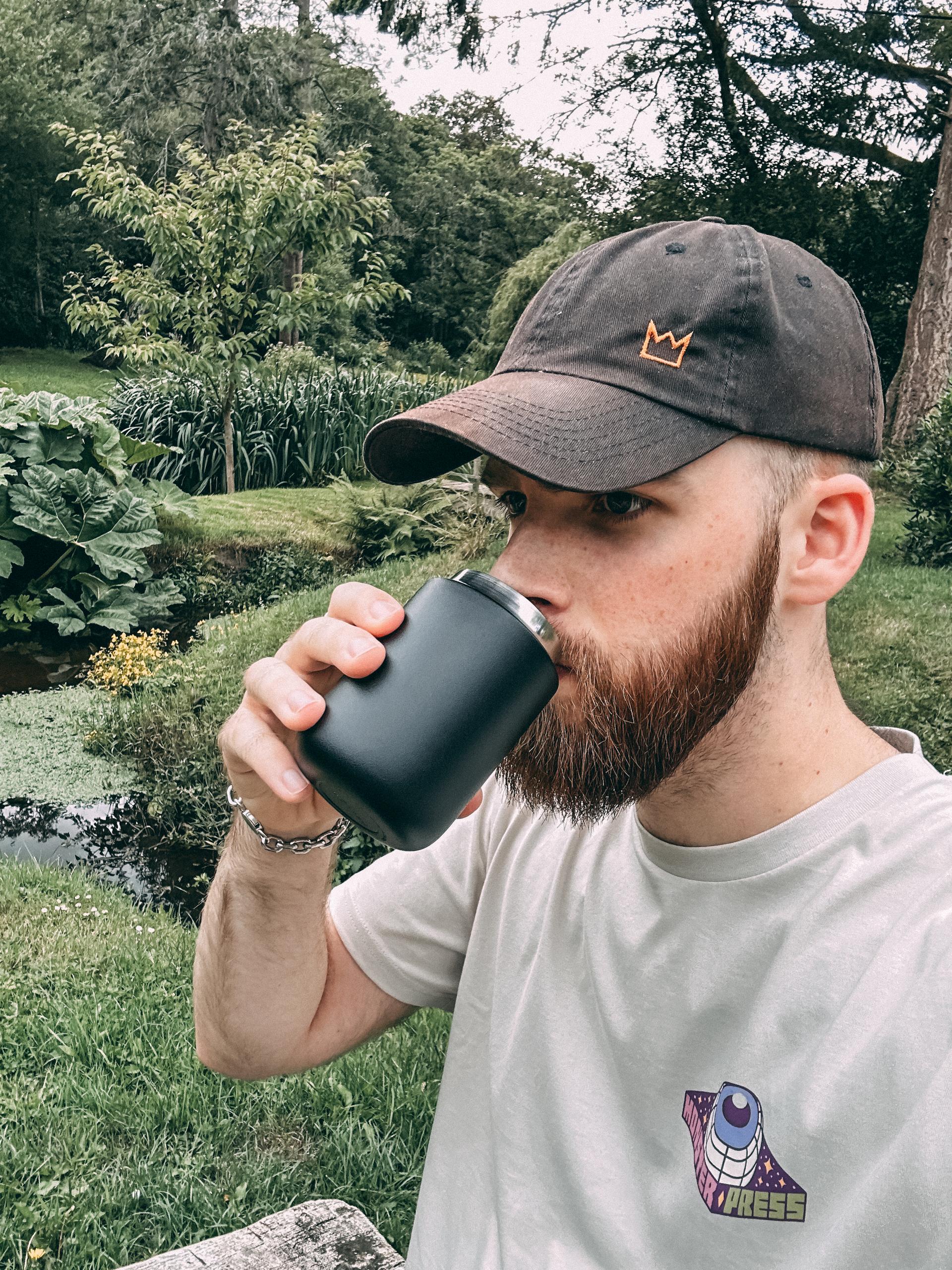 Otter drinking coffee.